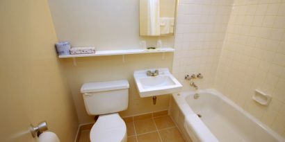 Guest bathroom with tub at Alexandra Hotel.