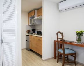 Day room with work station and coffee station at Suites Coben.