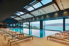 Indoor pool with loungers at Le Méridien Bodrum Beach Resort.