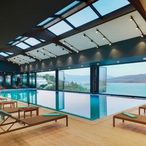 Indoor pool with loungers at Le Méridien Bodrum Beach Resort.