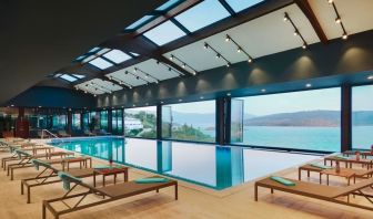 Indoor pool with loungers at Le Méridien Bodrum Beach Resort.