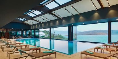 Indoor pool with loungers at Le Méridien Bodrum Beach Resort.