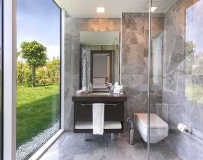 Guest bathroom with shower at Le Méridien Bodrum Beach Resort.