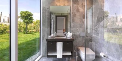 Guest bathroom with shower at Le Méridien Bodrum Beach Resort.