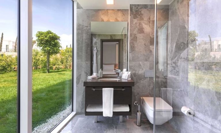 Guest bathroom with shower at Le Méridien Bodrum Beach Resort.