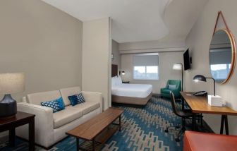 Spacious king room with lounge area at Four Points By Sheraton Fort Lauderdale Airport - Dania Beach.