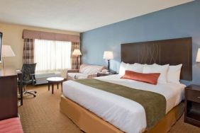 King bed with natural light at Best Western Plus Hotel & Conference Center.