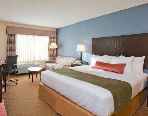 King bed with natural light at Best Western Plus Hotel & Conference Center.