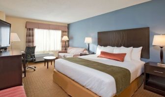 King bed with natural light at Best Western Plus Hotel & Conference Center.