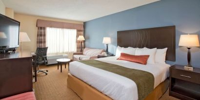 King bed with natural light at Best Western Plus Hotel & Conference Center.