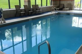 Indoor pool with seating area at Best Western Plus Hotel & Conference Center.