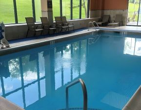 Indoor pool with seating area at Best Western Plus Hotel & Conference Center.