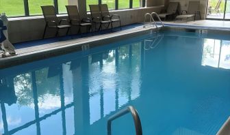 Indoor pool with seating area at Best Western Plus Hotel & Conference Center.