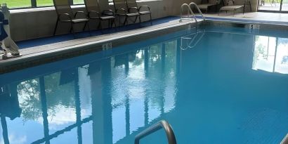 Indoor pool with seating area at Best Western Plus Hotel & Conference Center.