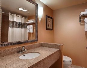 Private guest bathroom with shower at Best Western Plus Hotel & Conference Center.