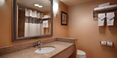 Private guest bathroom with shower at Best Western Plus Hotel & Conference Center.