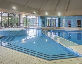 Indoor pool with seating area at DoubleTree By Hilton Glasgow Westerwood.