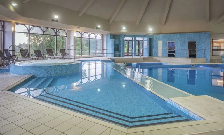 Indoor pool with seating area at DoubleTree By Hilton Glasgow Westerwood.