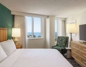 Romantic king room with TV at Embassy Suites By Hilton Deerfield Beach Resort & Spa.