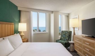 Romantic king room with TV at Embassy Suites By Hilton Deerfield Beach Resort & Spa.