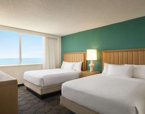 Two queen beds with TV and ocean view at Embassy Suites By Hilton Deerfield Beach Resort & Spa.