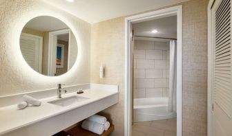 Guest bathroom with shower at Embassy Suites By Hilton Deerfield Beach Resort & Spa.