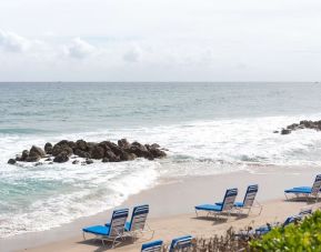 Beach loungers on the beach at Embassy Suites By Hilton Deerfield Beach Resort & Spa.