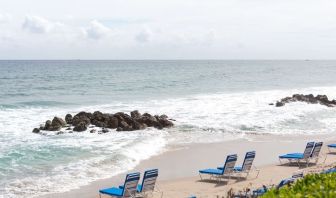 Beach loungers on the beach at Embassy Suites By Hilton Deerfield Beach Resort & Spa.