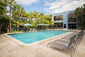 Outdoor pool with pool loungers at Regency Miami Airport By Sonesta.