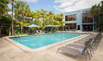 Outdoor pool with pool loungers at Regency Miami Airport By Sonesta.