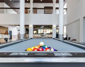 Game room and pool table at Regency Miami Airport By Sonesta.