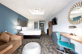 Spacious king room with lounge area at Regency Miami Airport By Sonesta.