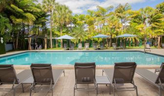 Outdoor pool with loungers at Regency Miami Airport By Sonesta.