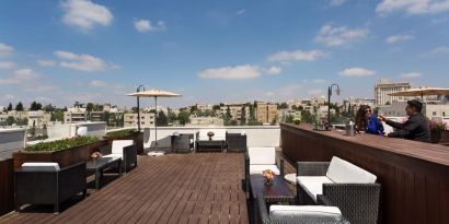 Rooftop terrace and chairs at Prima Royale Hotel.