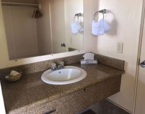 Guest bathroom with shower at Economy Inn, Fresno.