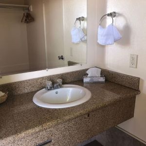 Guest bathroom with shower at Economy Inn, Fresno.