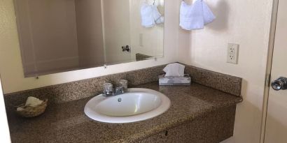 Guest bathroom with shower at Economy Inn, Fresno.