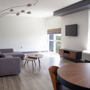 Hotel room with lounge and TV at Aloft Miami Doral.
