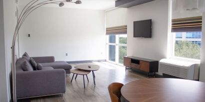 Hotel room with lounge and TV at Aloft Miami Doral.
