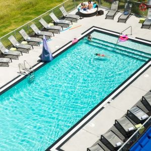 Outdoor pool with loungers at Aloft Miami Doral.
