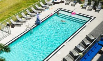 Outdoor pool with loungers at Aloft Miami Doral.
