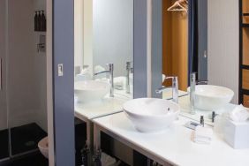 Guest bathroom with shower at Aloft Miami Doral.
