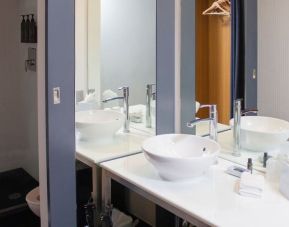 Guest bathroom with shower at Aloft Miami Doral.
