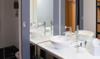 Guest bathroom with shower at Aloft Miami Doral.
