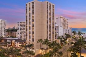 Hotel exterior at sunset at Hyatt Place Waikiki Beach.