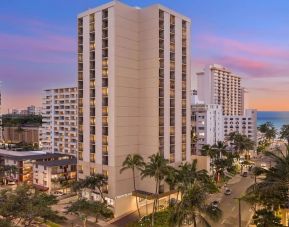 Hotel exterior at sunset at Hyatt Place Waikiki Beach.