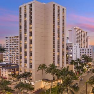 Hotel exterior at sunset at Hyatt Place Waikiki Beach.