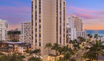 Hotel exterior at sunset at Hyatt Place Waikiki Beach.