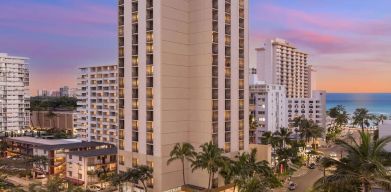 Hotel exterior at sunset at Hyatt Place Waikiki Beach.