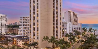 Hotel exterior at sunset at Hyatt Place Waikiki Beach.